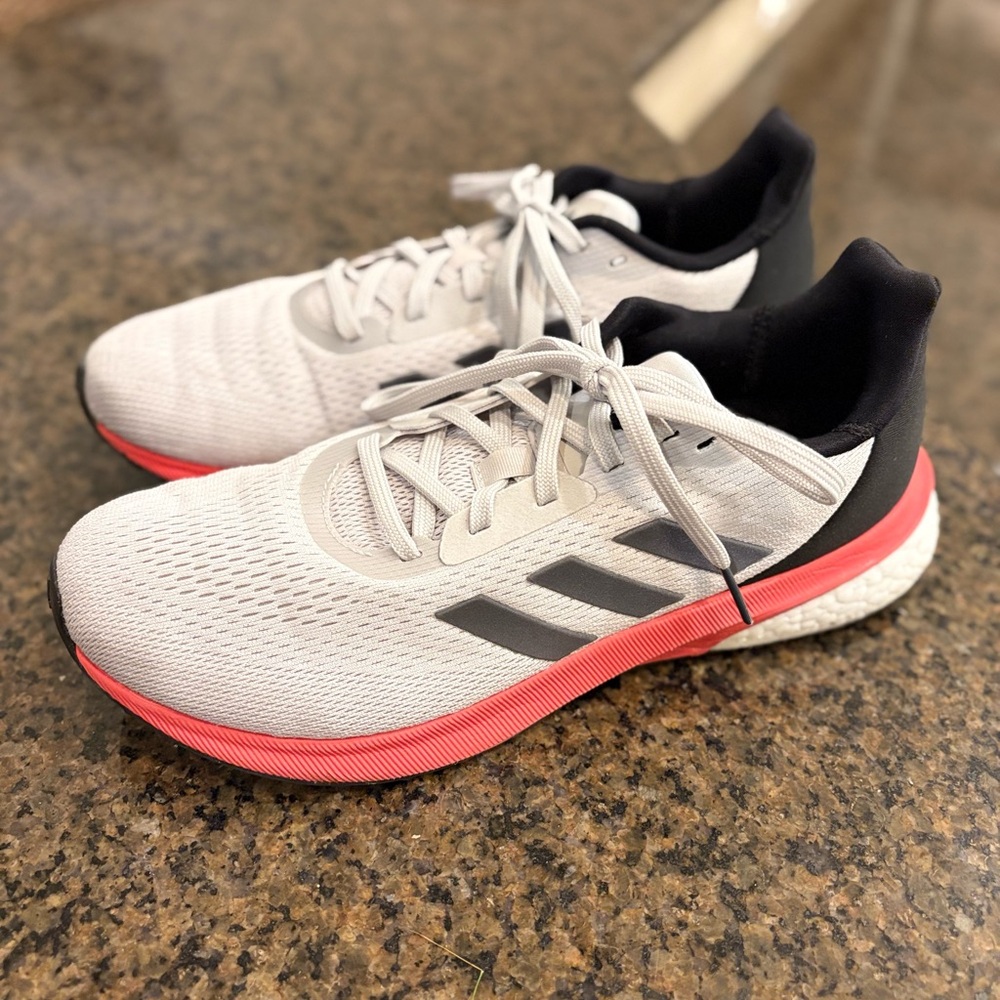 NWOB! Adidas Women’s size 9 Running Shoes with pinkish red trim.